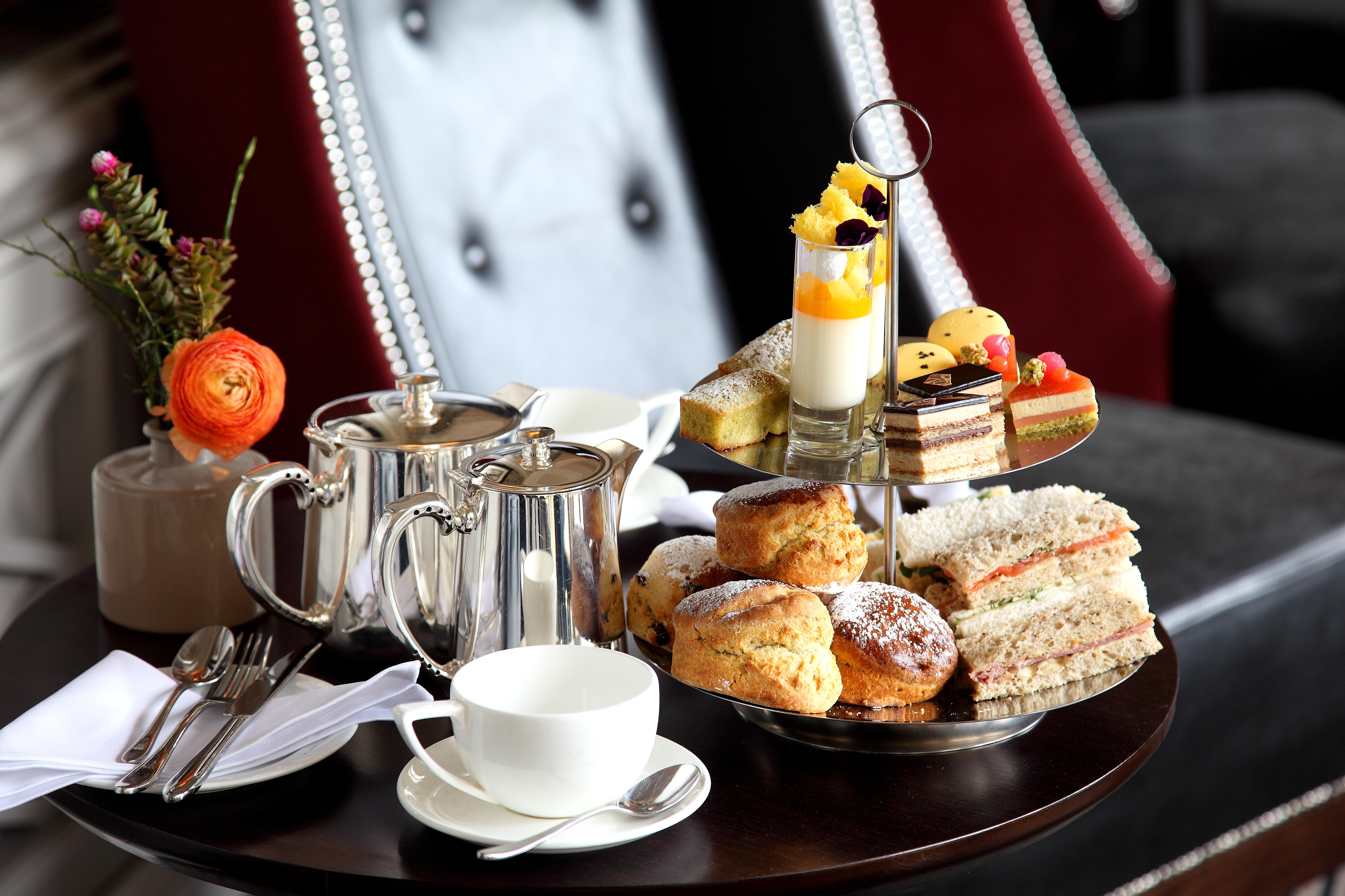 Macdonald Bath Spa Hotel Eksteriør bilde The photo depicts an elegantly arranged afternoon tea setting. There is a tiered stand filled with a variety of treats, including scones, sandwiches, and small desserts like cakes and pastries. Accompanying this is a teapot and a cup on the table, su